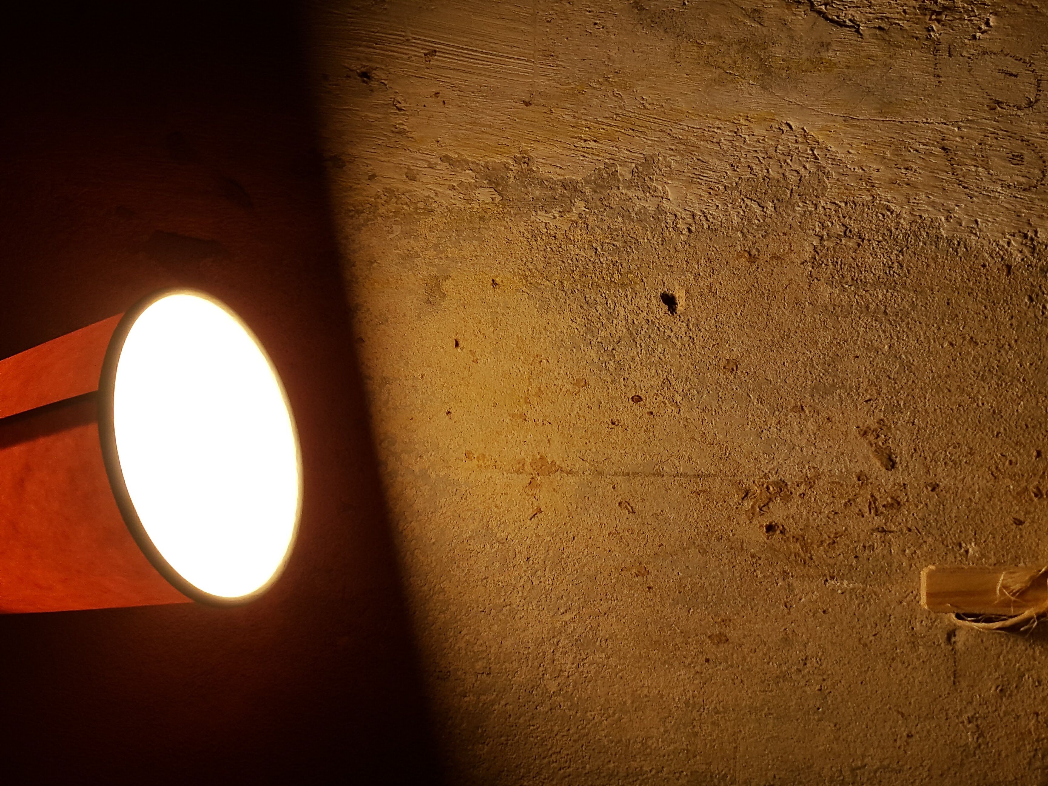 an old lamp iluminating a wall