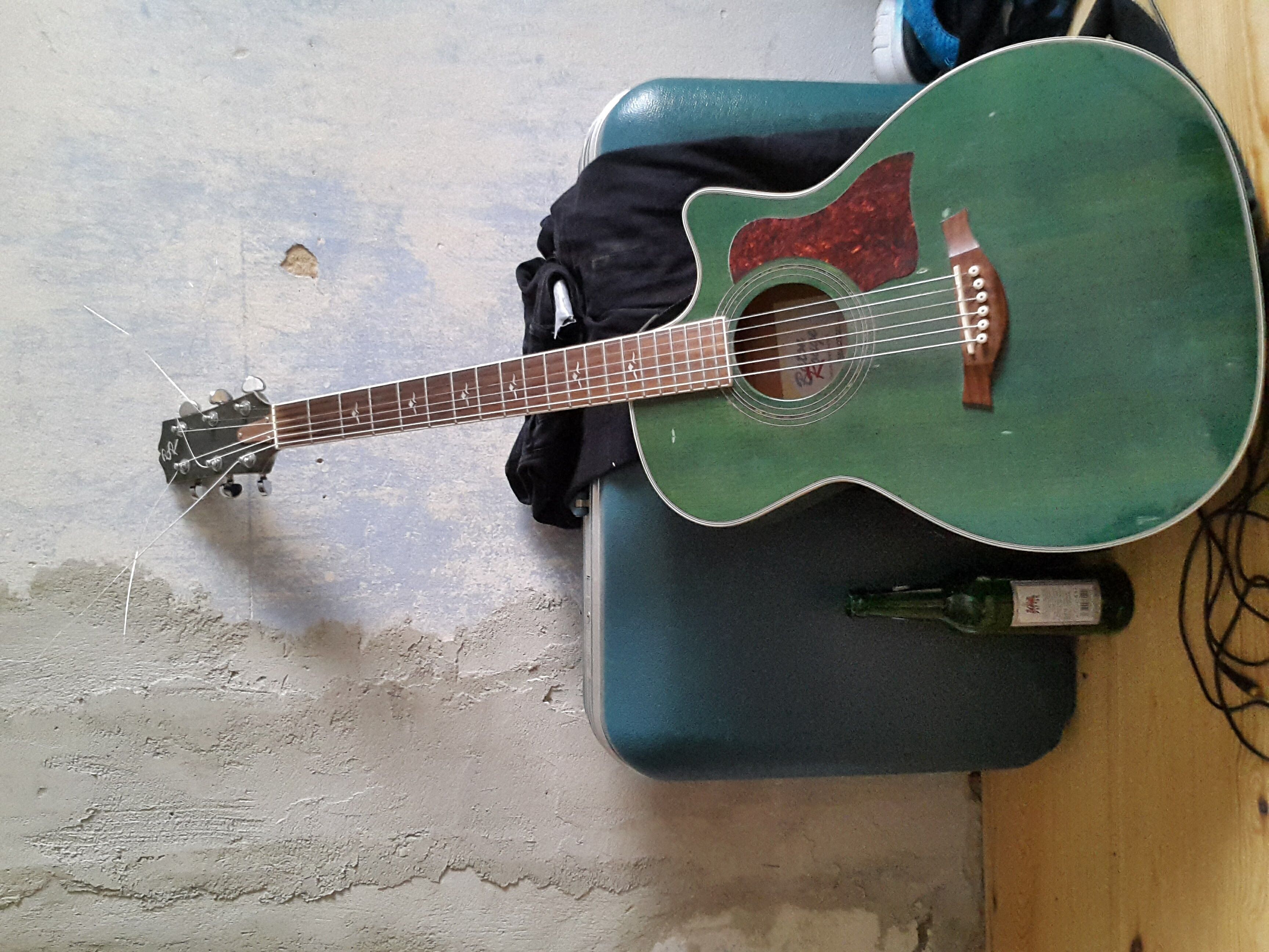 my guitar in front of my green suitcase